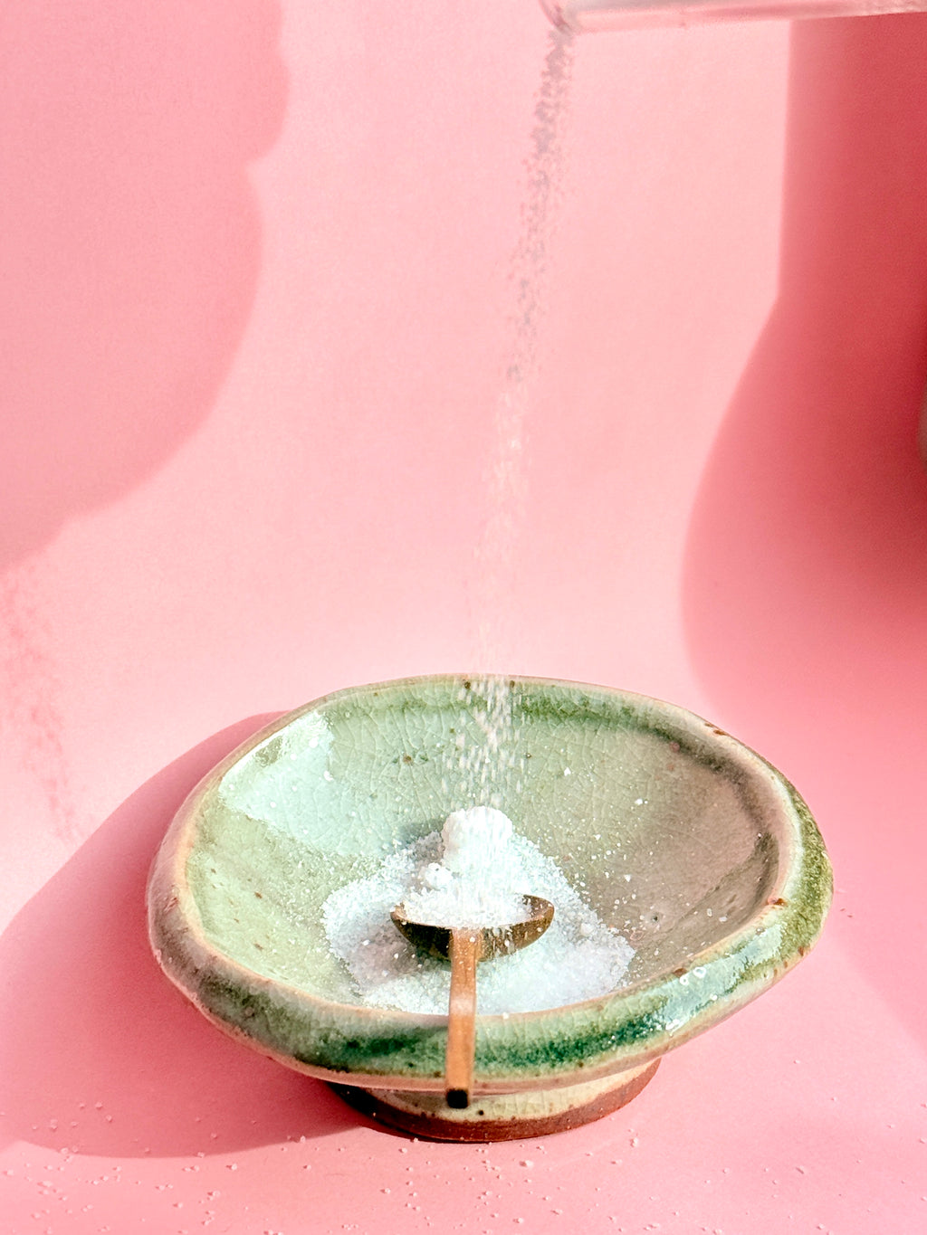 Green handbuilt ceramic salt bowl with glossy glaze with salt 