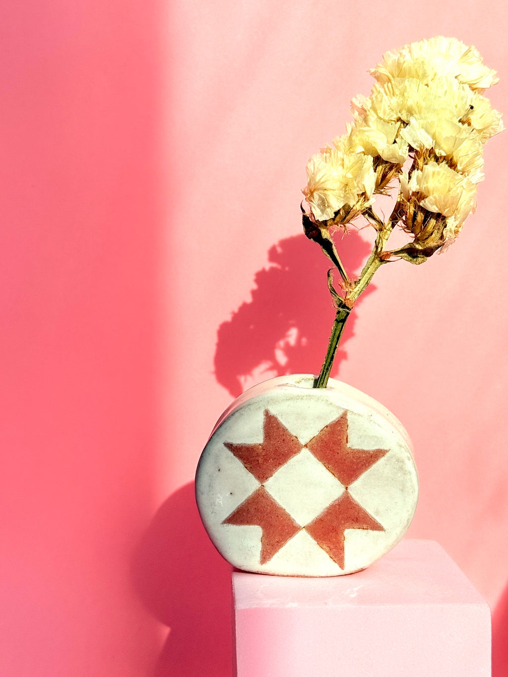 Quilt-inspired handmade ceramic bud vase on pink background made by Bunzy
