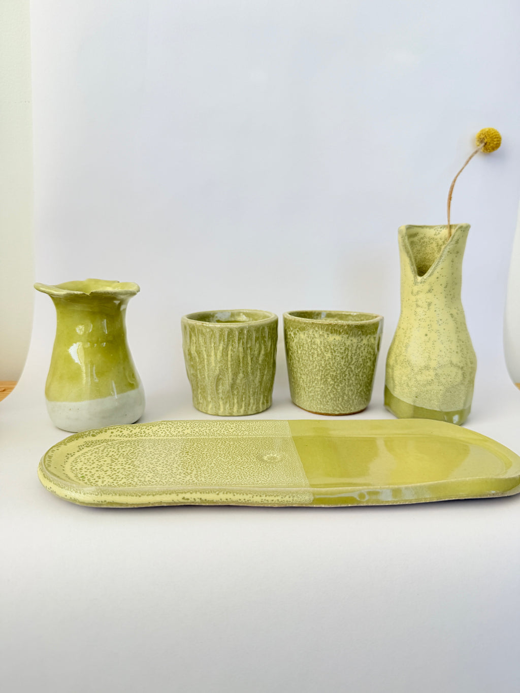 Light green ceramic items on a white background