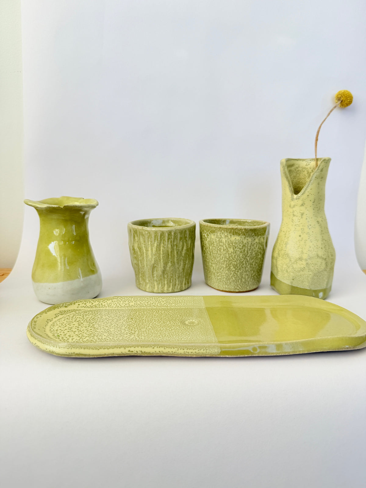 Light green ceramic items on a white background