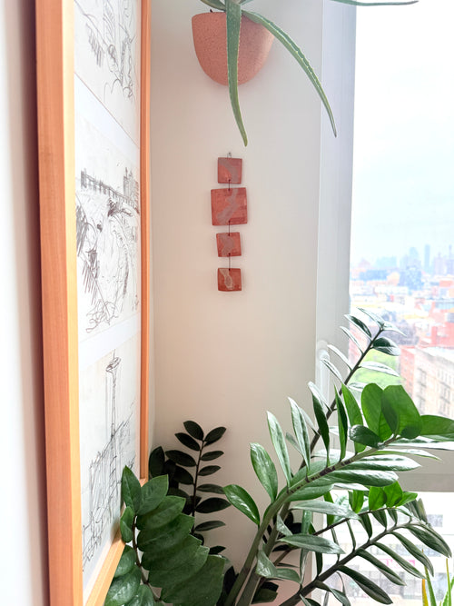 Handmade ceramic wall hanging with boho geometric pattern