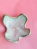 Hand built ceramic trinket dish with soft pastel glaze and organic scalloped shape
