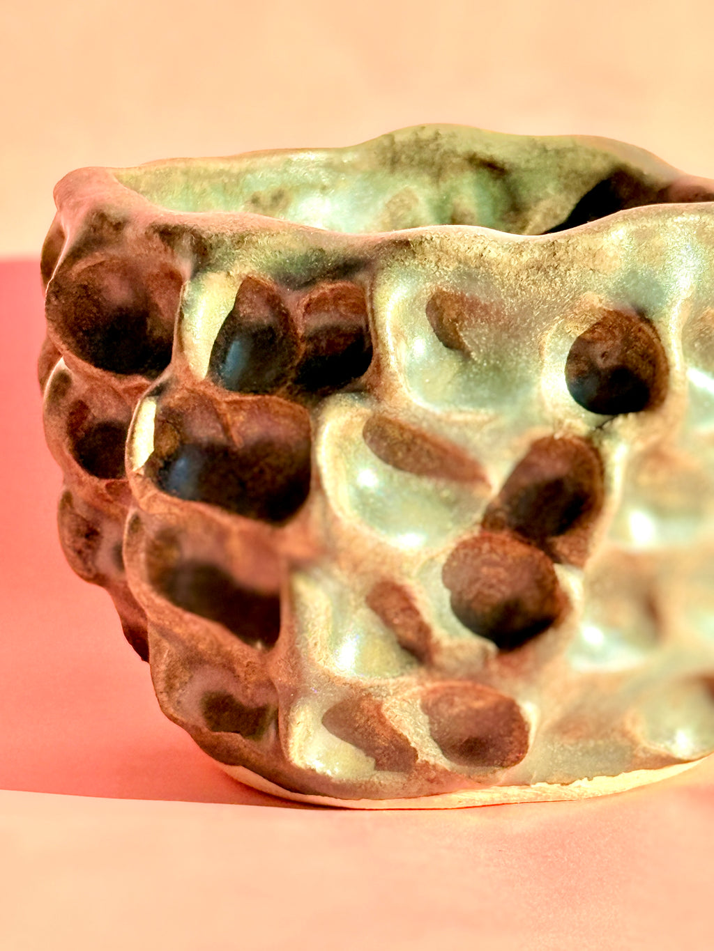 Close-up of handcrafted stoneware bowl showing sculptural surface texture