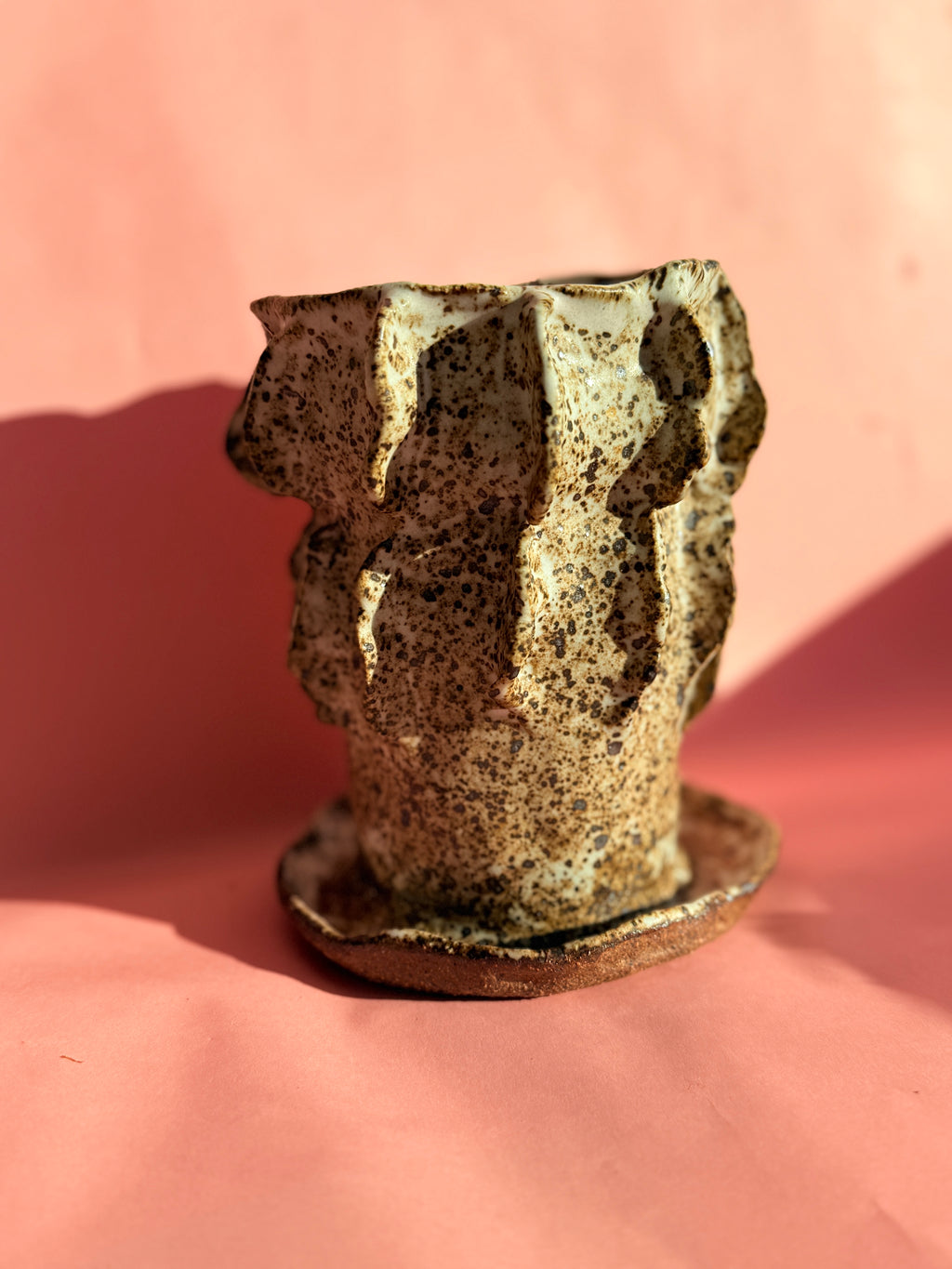 Ceramic sculptural vase in cream and brown glaze, front view