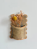 Handmade ceramic wall pocket vase with dried flowers, rustic stoneware finish