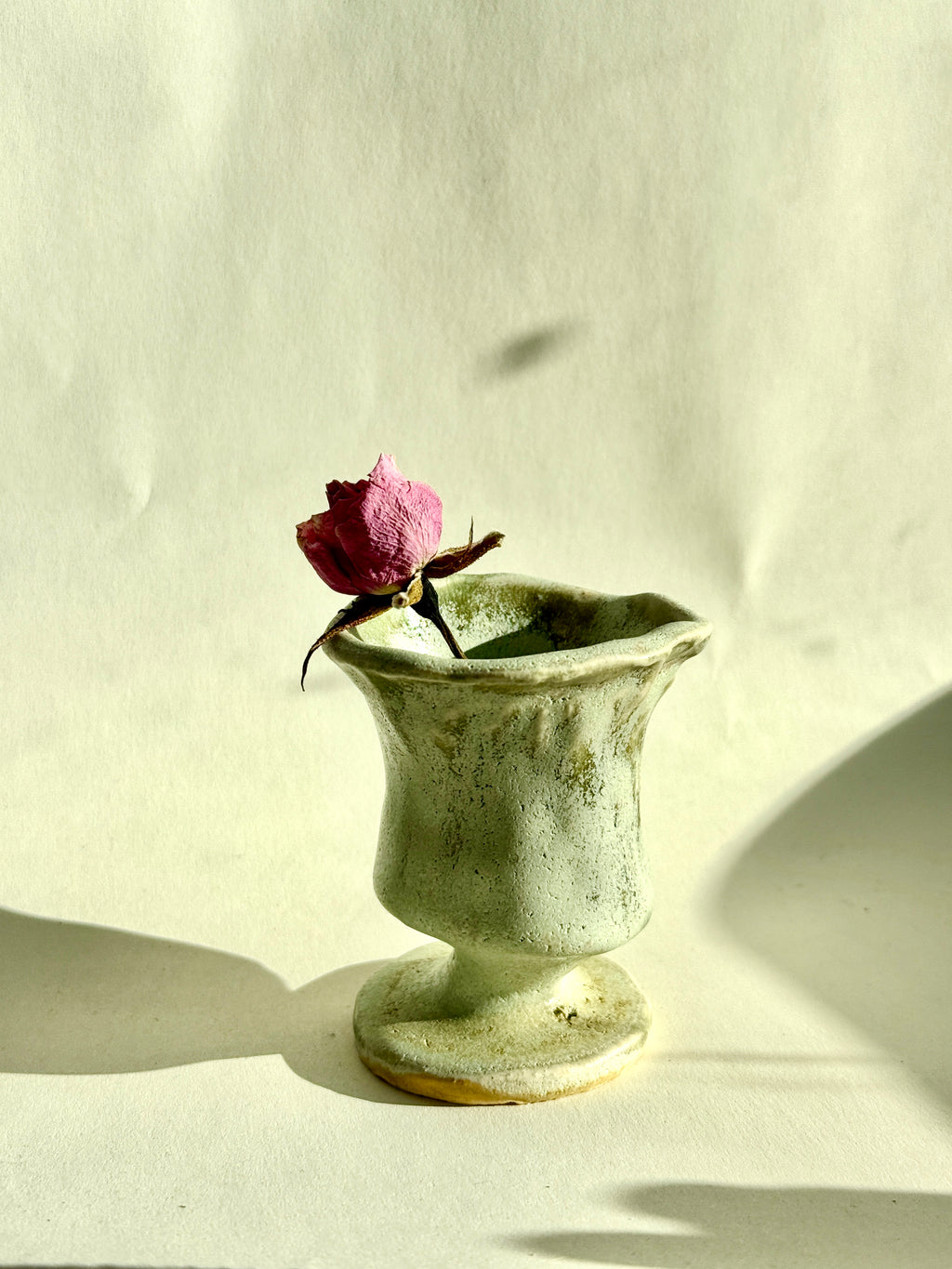 Bunzy mini green ceramic bud vase handmade from stoneware with pedestal base.