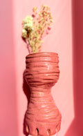 Tall handmade pink ceramic vase with sculptural form and textured surface