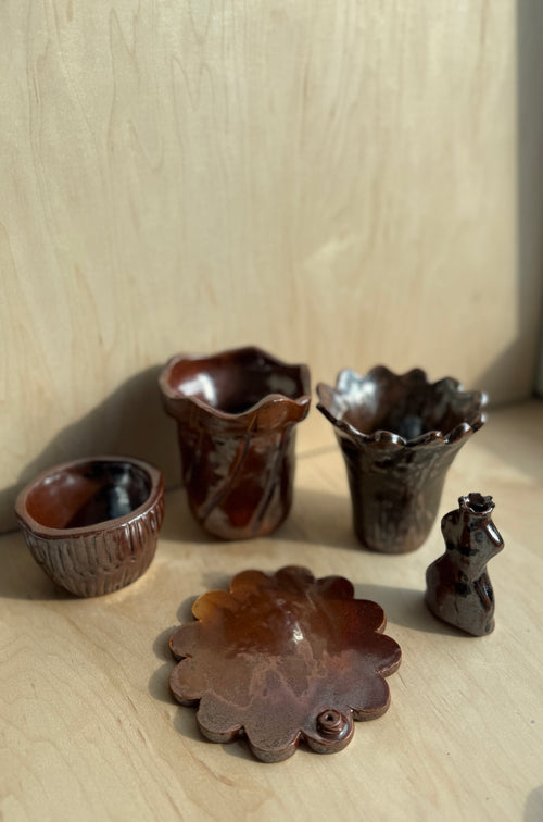Handbuilt ceramic cup with other bronze items