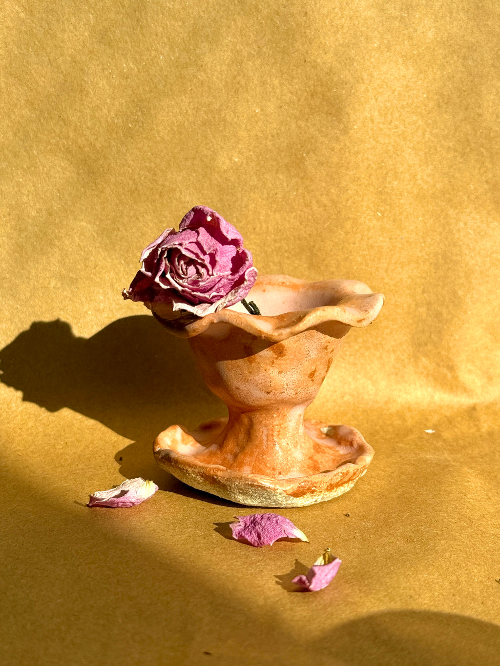 Hand-built stoneware pink pedestal incense cone holder with sculptural ruffled edges and organic form