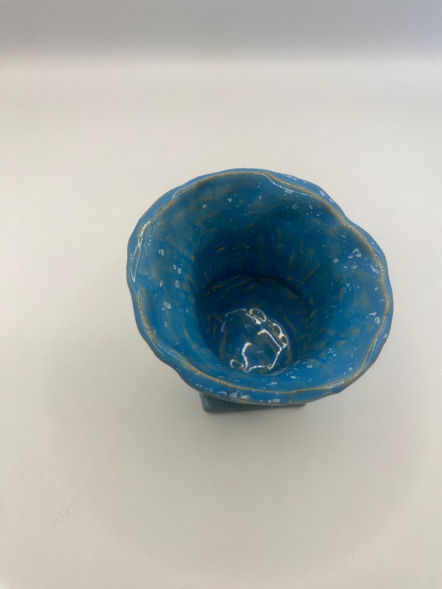 Small blue speckled ceramic vase, perfect for displaying flowers or as a decorative accent piece in modern home decor.