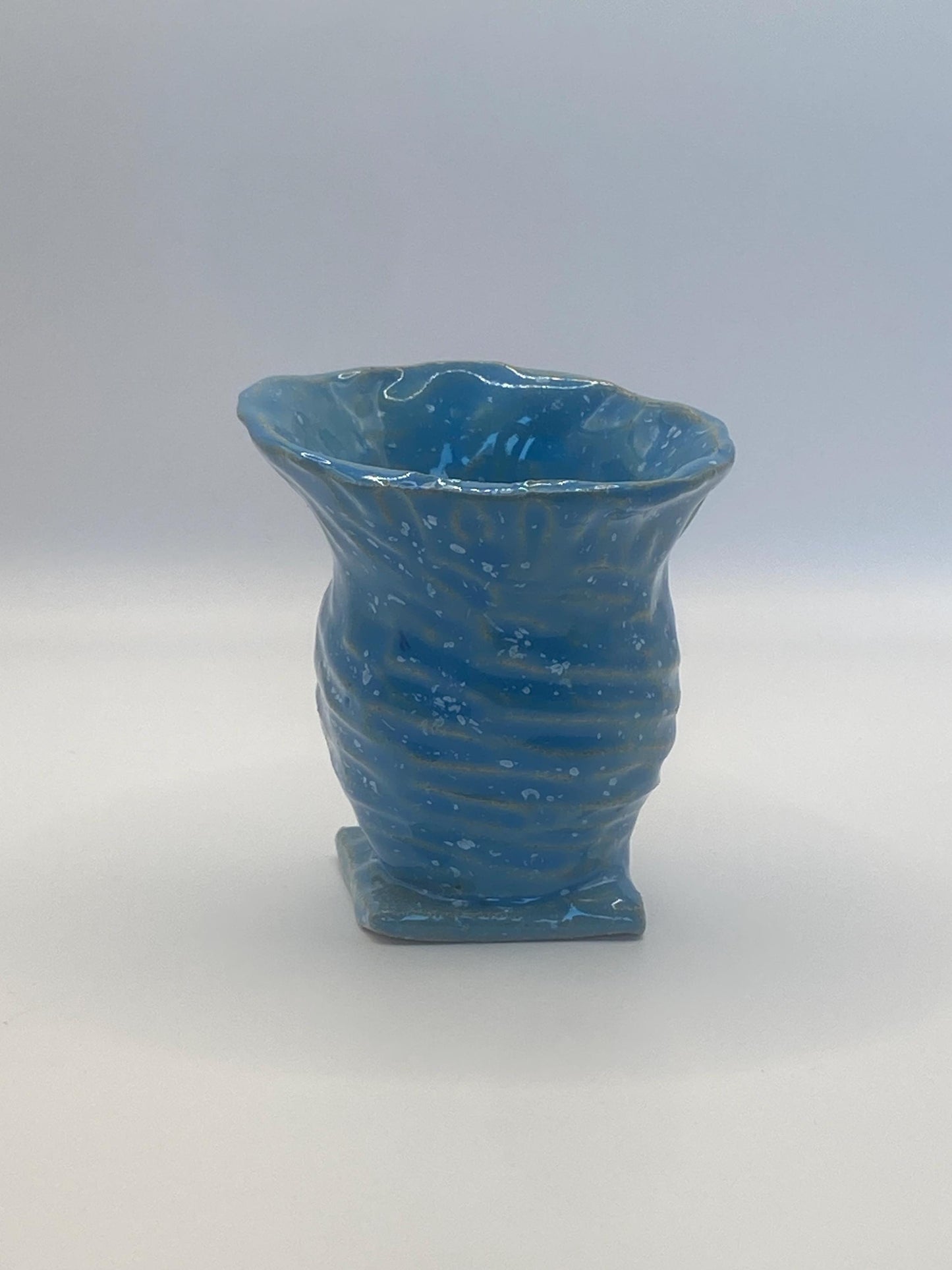 Small blue speckled ceramic vase, perfect for displaying flowers or as a decorative accent piece in modern home decor.