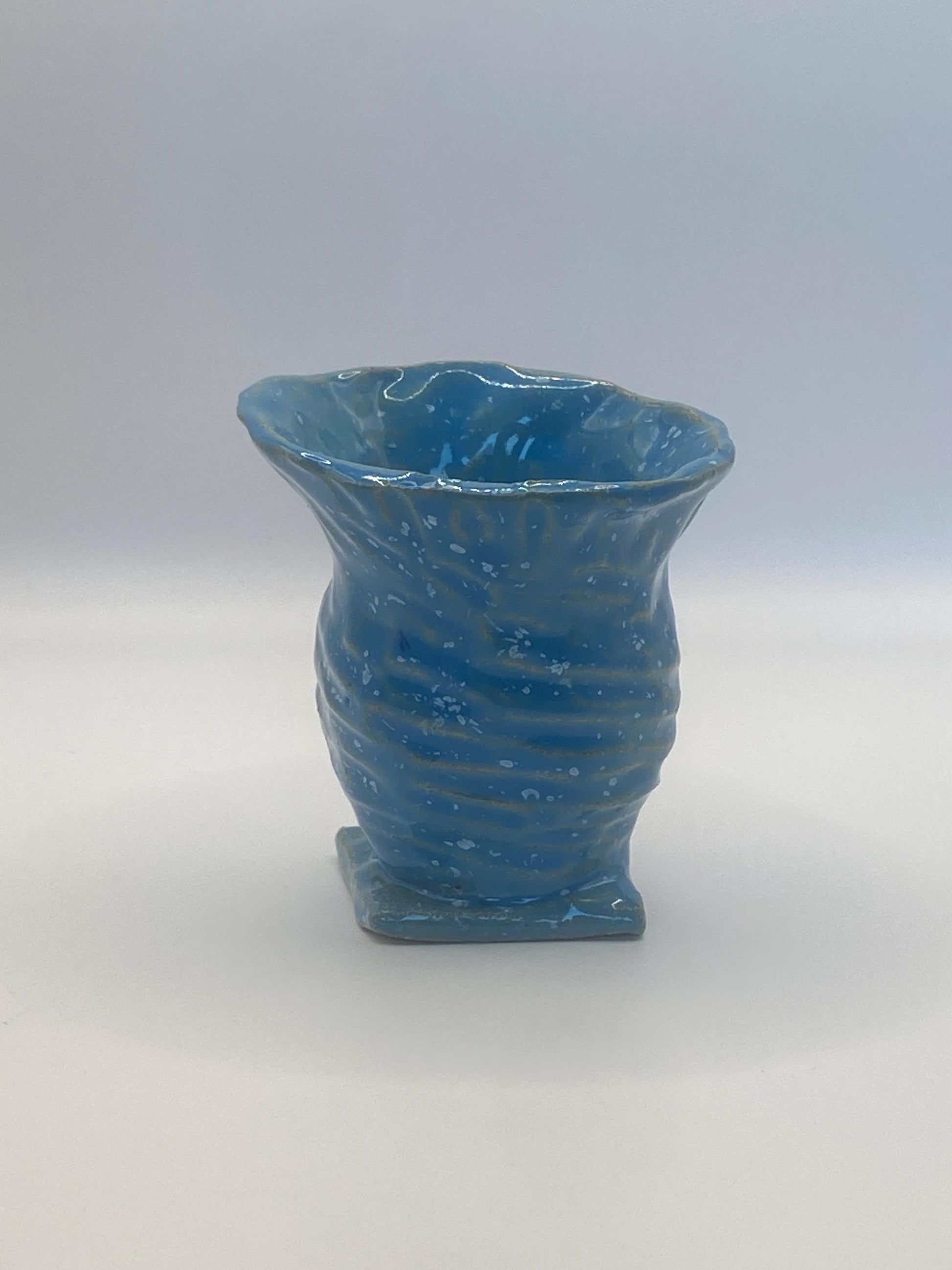 Small blue speckled ceramic vase, perfect for displaying flowers or as a decorative accent piece in modern home decor.