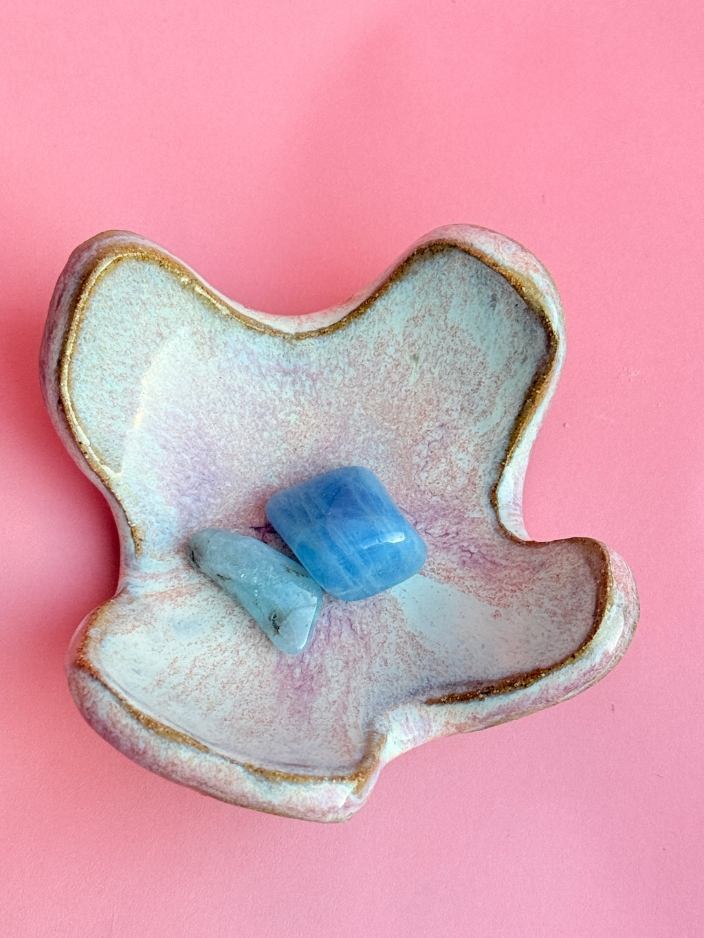 Top view of small hand built ceramic trinket dish with flowing organic edges