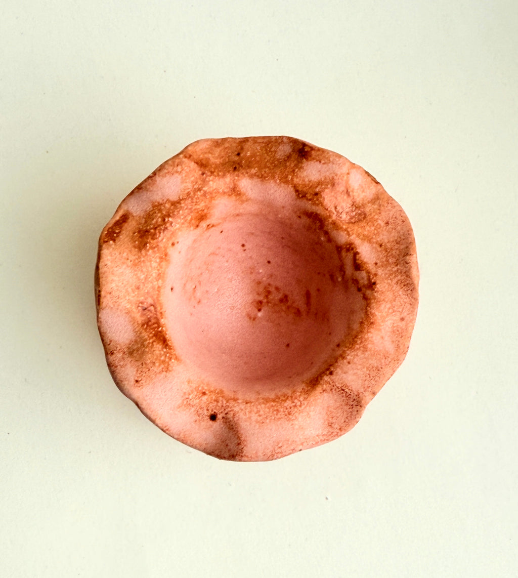 Hand-built stoneware pink pedestal incense cone holder with sculptural ruffled edges and organic form